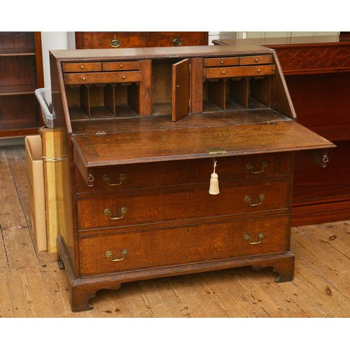 673 - A Georgian Oak & Banded Bureau fitted with Four graduated Drawers, Slides, Fitted interior, Pigeon H... 