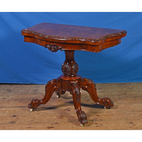 683 - A Victorian Walnut Veneered Butterfly Top Carved Edge Card Table with a Circular Baize resting on Fo... 