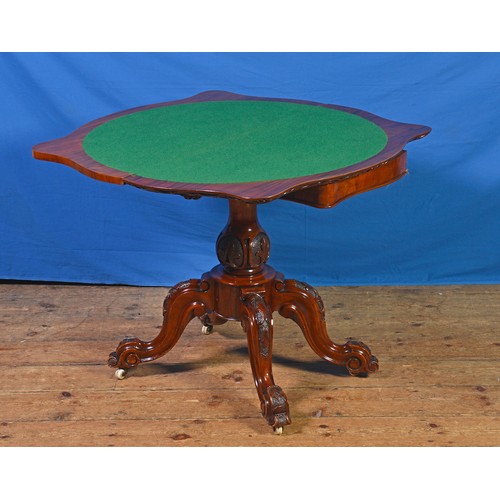 683 - A Victorian Walnut Veneered Butterfly Top Carved Edge Card Table with a Circular Baize resting on Fo... 