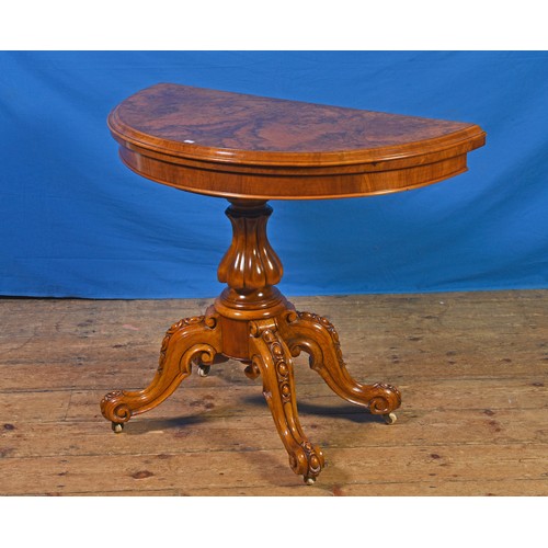 686 - A Victorian Walnut veneered Fold-Over Top Card Table resting on Four Ovo Carved Legs & Central Pedes... 