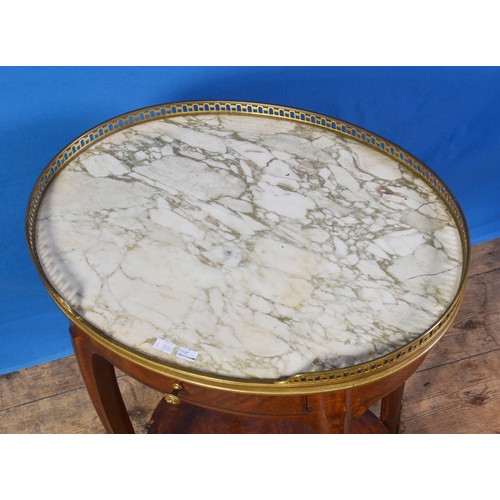 691 - An Edwardian Oval Drink's/Side Table with Ormolu Feet & surround to a Marble Top. Measuring: 65cms h... 