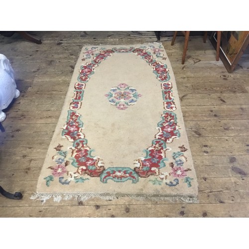 694 - A Vintage Ivory coloured Rug with Floral Border. Measuring: 180cms x 98cms.