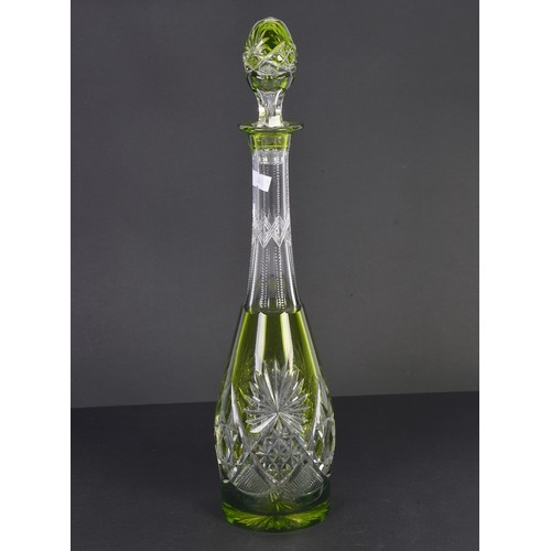 993 - A Green overlaid Glass Tear dropped faceted Decanter & Stopper, Signed. Measuring: 41cms high.