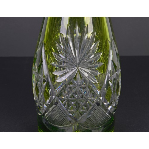 993 - A Green overlaid Glass Tear dropped faceted Decanter & Stopper, Signed. Measuring: 41cms high.