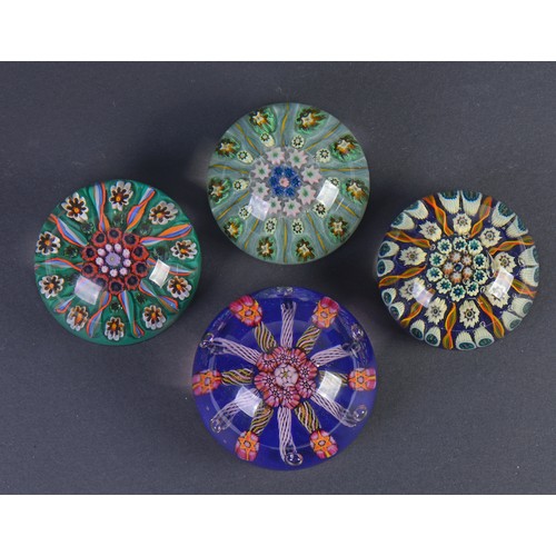 997 - A French Glass Catherine Wheel Paperweight & three Glass Paperweights decorated with flowers.