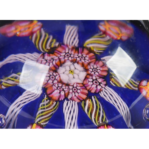 997 - A French Glass Catherine Wheel Paperweight & three Glass Paperweights decorated with flowers.