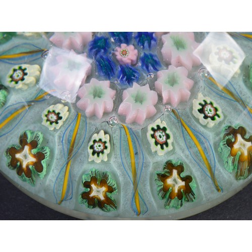 997 - A French Glass Catherine Wheel Paperweight & three Glass Paperweights decorated with flowers.