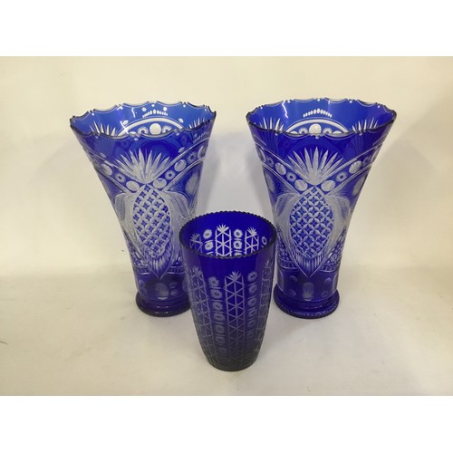 1000 - A Pair of Blue Cased Flared Lipped Cut Glass Trumpet Vases with floral Ribbon & faceted star decorat... 