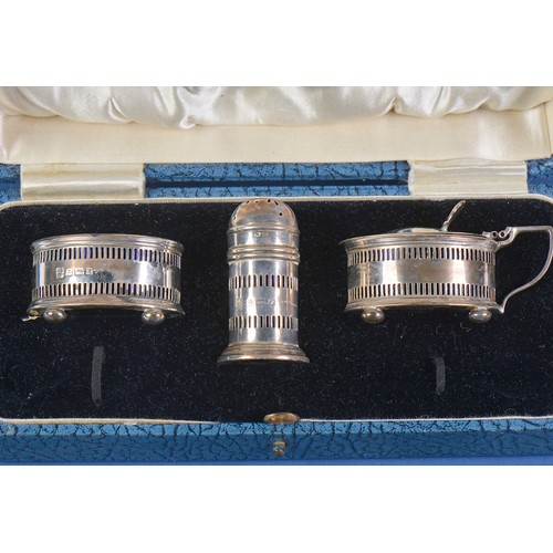 33 - A Three Piece Silver pierced Cruet Set with Blue Glass Liners by the Northern Goldsmiths Company in ... 