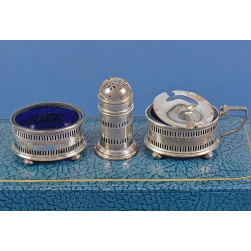 33 - A Three Piece Silver pierced Cruet Set with Blue Glass Liners by the Northern Goldsmiths Company in ... 