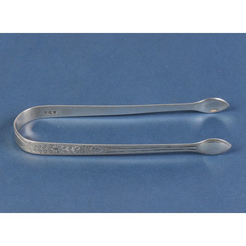 61 - A Pair of Georgian Silver & Bright Cut engraved Sugar Tongs. Weighing: 30 grams.