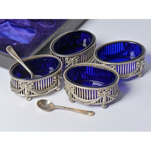 69 - An Elkington & Company Set of Four Silver pierced side swag & bow Salt Cellars with Two Spoons in Ca... 