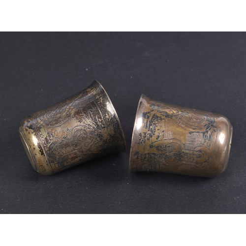 75 - A Pair of Russian Silver Vodka Tots with engraved decoration, marked 84BC1870 - St. George. Weighing... 