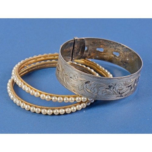 207 - A Silver Bangle, a Pearl Bangle & an Indian Pearl mounted Bride's Bangle.