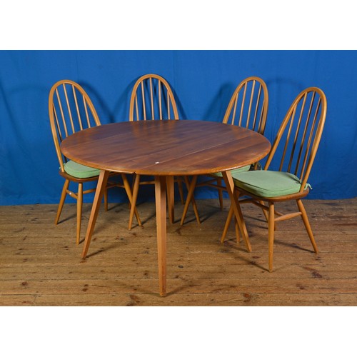 551 - An Ercol Drop Flap Table with Four Chairs.