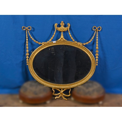 587 - A Regency Oval Wall Mirror decorated with a Vase & Swags & Bows dot egg & dart Husk Decoration. Meas... 