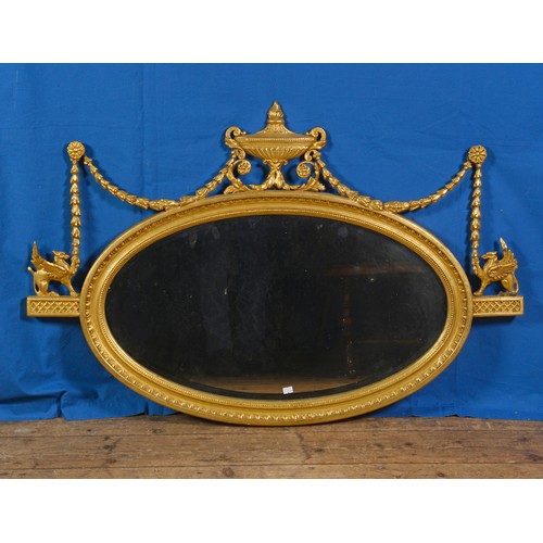 588 - A Regency Oval Wall Mirror decorated with a Vase & Swags & Bows dot egg & dart Husk Decoration with ... 