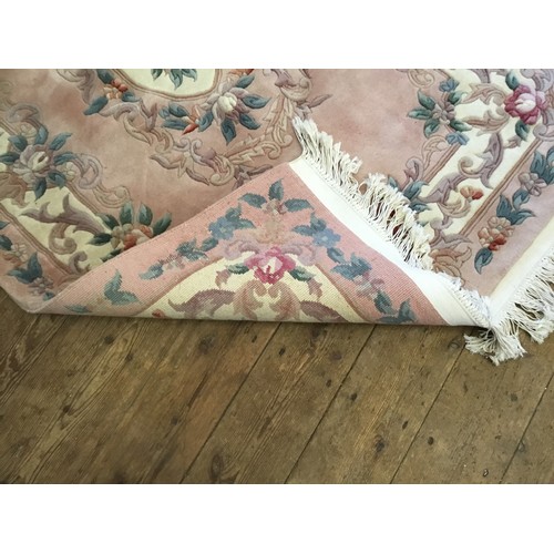 594 - A Salmon Pink Ground Chinese Floral decorated Cut & Shaped Fringe bordered Rug. Measuring: 200cms x ... 