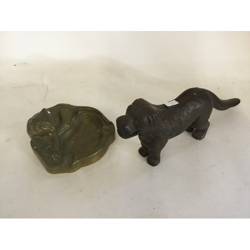 785 - A Bronzed Pipe Rest designed with a crouching lion & a pair of Victorian Dog Nut Crackers.