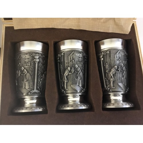 798 - A Set of Three Zinn Pewter Goblets decorated with Town Criers, Romantic Couples, a Miniature Tea Urn... 