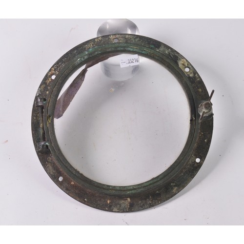 920 - A Brass Nautical Port Hole. Measuring: 18cms across.