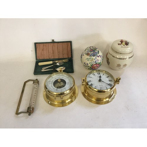 923 - A Brass Barometer & a Brass Clock along with two Jars, a Thermometer & a Boxed Knife, Fork & Spoon.