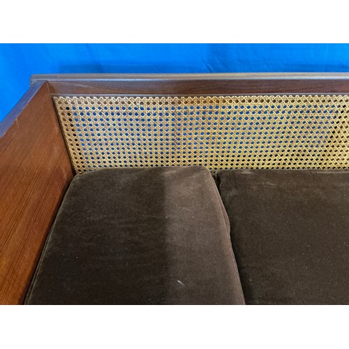 536 - A 1950s design Single Cane Backed Low Down Sofa with Tray Type Folding Ends resting on Turned Legs. ... 
