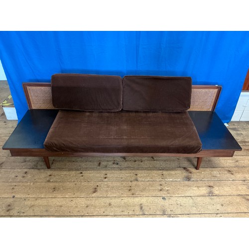 536 - A 1950s design Single Cane Backed Low Down Sofa with Tray Type Folding Ends resting on Turned Legs. ... 