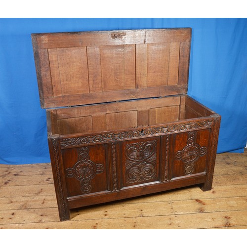 559 - An Antique Oak Coffer with three Carved panelled front, double panel ends & resting on squared lined... 