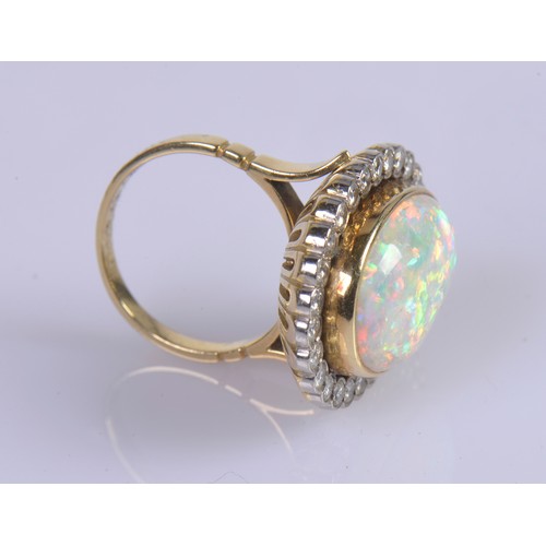 208 - A Stunning 18ct Ladies Oval Opal & Diamond Edged Colette set Dress Ring mounted with approximately 3... 