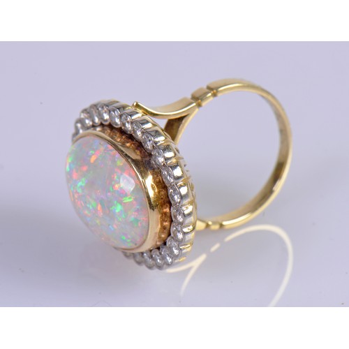 208 - A Stunning 18ct Ladies Oval Opal & Diamond Edged Colette set Dress Ring mounted with approximately 3... 