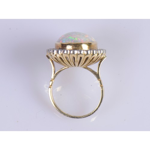 208 - A Stunning 18ct Ladies Oval Opal & Diamond Edged Colette set Dress Ring mounted with approximately 3... 