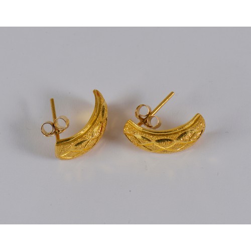 10 - A pair of half hoop engraved earrings, in a high carat gold.