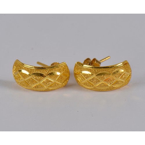 10 - A pair of half hoop engraved earrings, in a high carat gold.