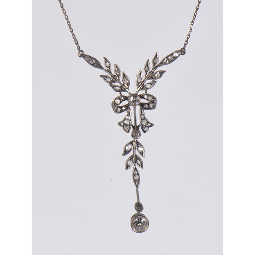 27 - An Edwardian diamond necklace featuring a delicate leaf and bow design, set with diamonds, the large... 
