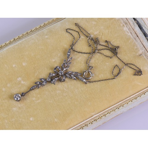 27 - An Edwardian diamond necklace featuring a delicate leaf and bow design, set with diamonds, the large... 
