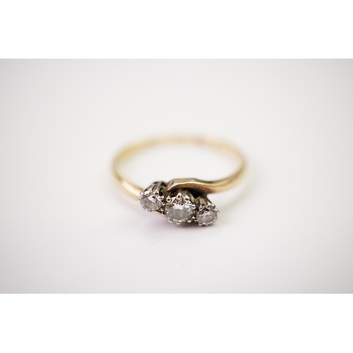 33 - A gold and diamond trilogy ring, set with a central diamond of approximately 0.20ct and two surround... 