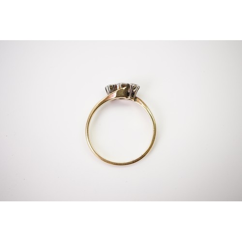 33 - A gold and diamond trilogy ring, set with a central diamond of approximately 0.20ct and two surround... 