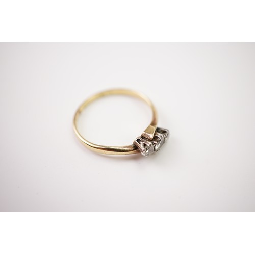 33 - A gold and diamond trilogy ring, set with a central diamond of approximately 0.20ct and two surround... 
