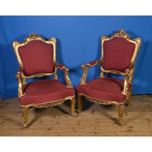 647 - A Pair of French design Rococo & Scroll Backed Swept Open Armed Fauteuil Chairs resting on Shaped Ca... 