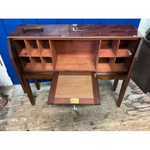 654 - A Cuban Mahogany Veneered Drop-Flap Gentleman's Club Cabinet in a Flame Veneer with a Drop Down Flap... 