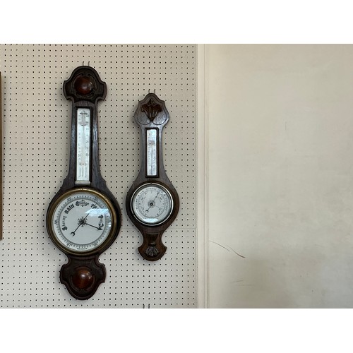 674 - A 1920s Oak Cased Barometer/Thermometer & one other.