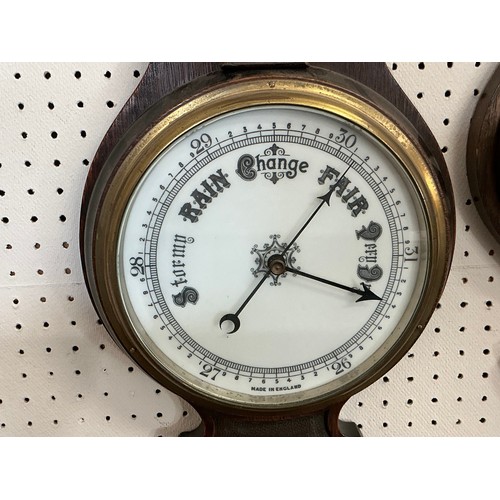 674 - A 1920s Oak Cased Barometer/Thermometer & one other.