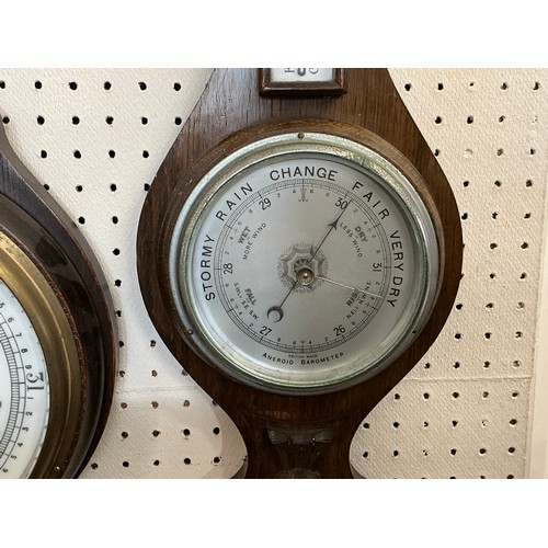 674 - A 1920s Oak Cased Barometer/Thermometer & one other.