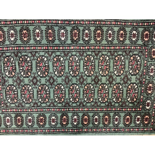 677 - A Green Ground Central 18 Gull, Double Egg Border Persian Carpet/Rug. Measuring: 130cms x 80cms.