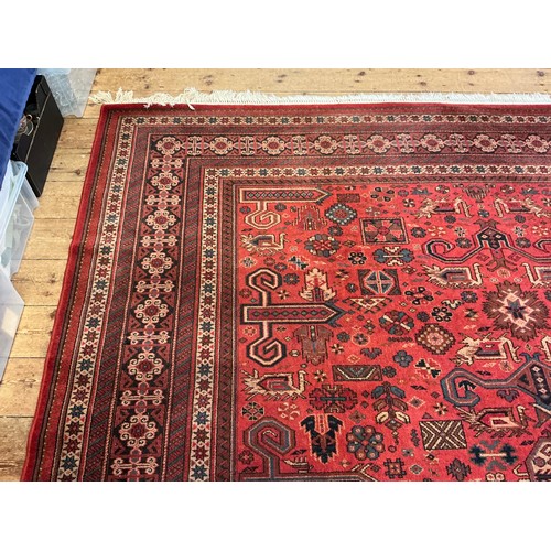 679 - A Large Louis de Poortere/Mossoul Red & Beige Ground Rug. Measuring: 373cms x 275cms. XXX