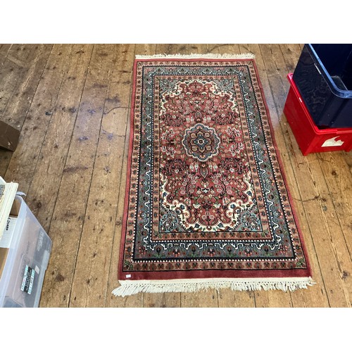 680 - A Burgundy Ground Central Gull decorated Floral Blue Bordered Rug. Measuring: 163cms x 90cms.