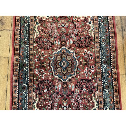 680 - A Burgundy Ground Central Gull decorated Floral Blue Bordered Rug. Measuring: 163cms x 90cms.