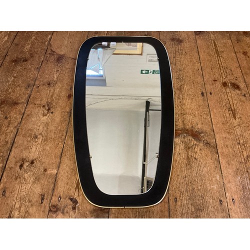 685 - A Gold Framed Retro Mirror. Measuring: 38cms x 73cms.