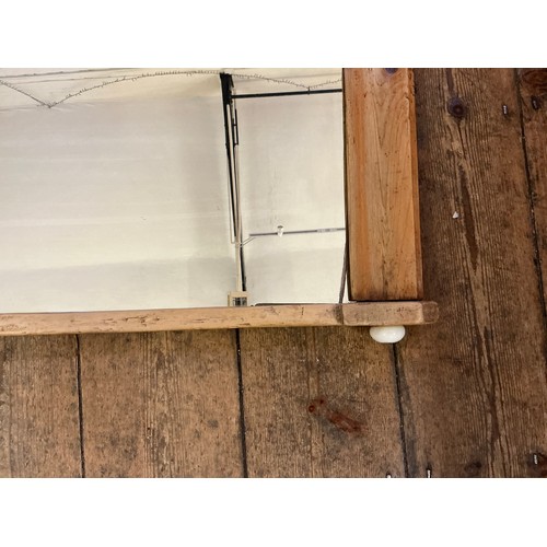 687 - A Pine Framed Over Mantle Mirror of Curved Form. Measuring: 97cms x 53cms.